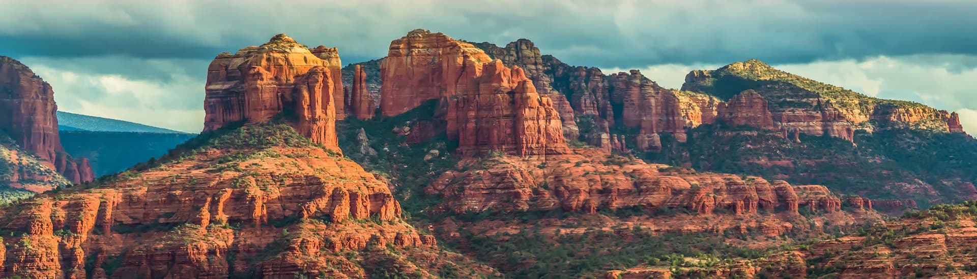 Red rock formations under a cloudy sky.